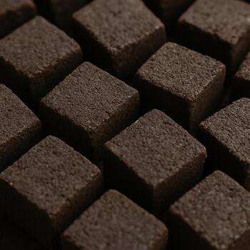 Close-up of coconut briquettes with square edges