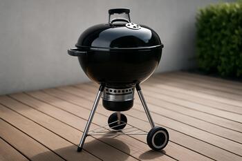 Glossy kettle grill on a low wooden deck