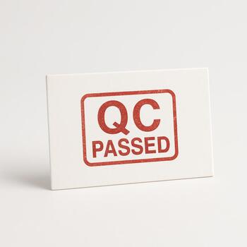 QC stamp on a small card