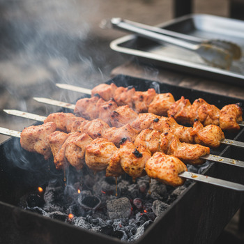 Tikka pieces on skewers getting first color